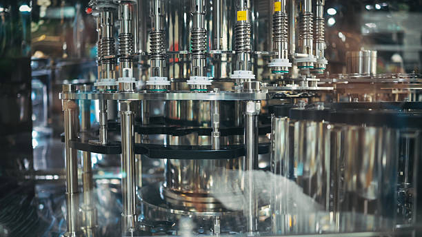 istock synchronized conveyor and multi-nozzle filling system in beverage or cosmetic production | automated stainless processing machine for mass packaging 2224035487