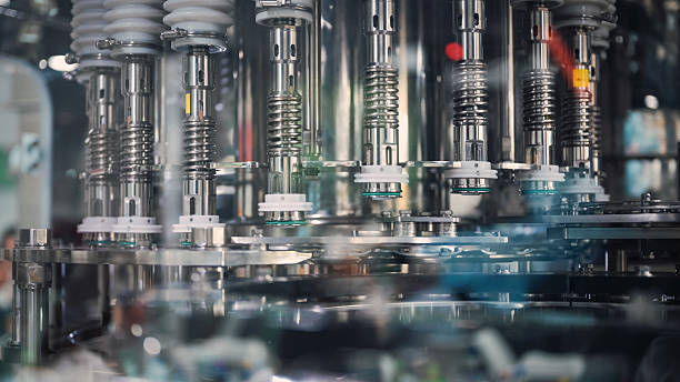 istock Automated filling machine for bottle packaging line industrial automation system with high speed bottle filler in sterile production environment for liquids and chemical solutions 2224035496