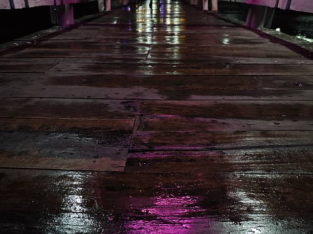 istock Wet wooden floor water reflection from lamp 2224035703