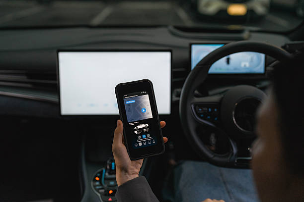 istock A woman exploring various features on the EV car's smart application through her smartphone 2224038244