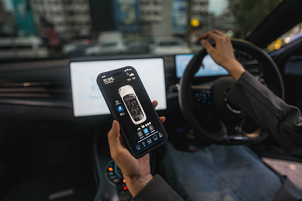 A woman using the EV car's app while driving home