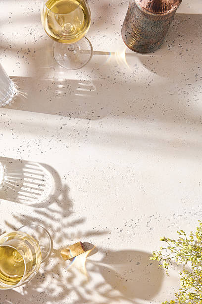 istock White wine glasses in bright sunlight, overhead minimal composition 2224038391