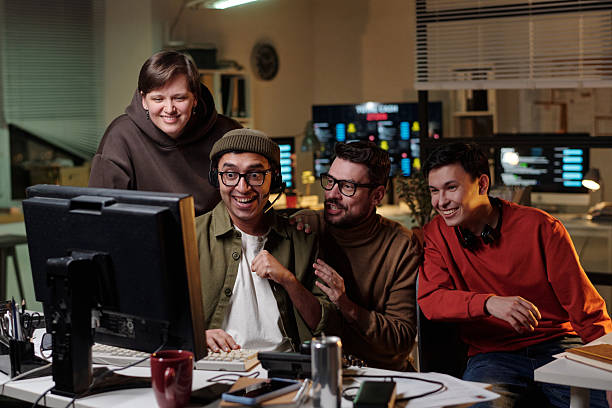istock Diverse Young Adults Collaborating in Scam Call Center Late at Night 2224038769