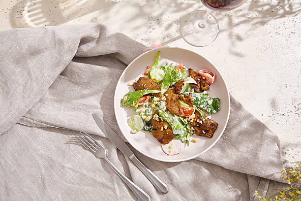 istock Chicken liver salad, bright natural lighting, overhead presentation on neutral linen background 2224039443