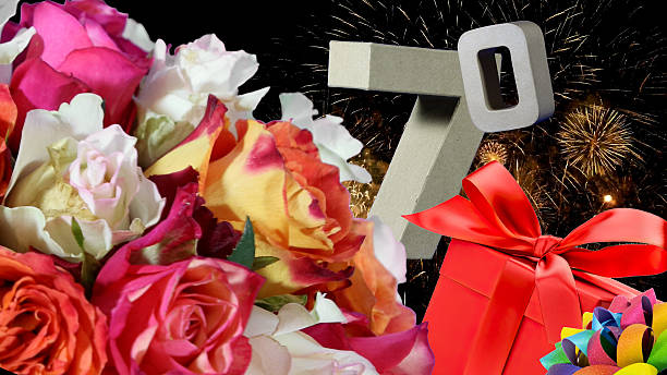 Years in dancing numbers , roses, gift, fireworks light sky. Age is 70