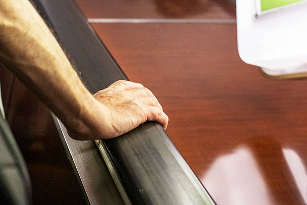 istock man's hand holding the railing on the escalator 2224043260