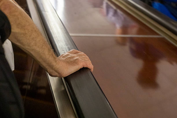 istock elderly man hand holding railing on escalator in subway 2224043320