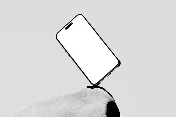 istock 3d render of Modern smartphone mockup with a blank screen on textured stones on a gray background. 2224045507