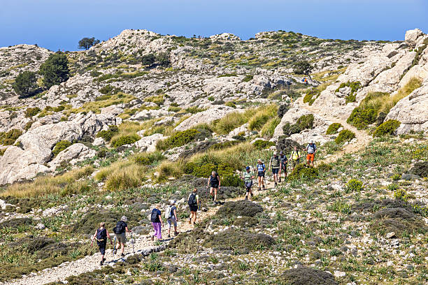 Mallorca, Spain-April, 2025: Hikers walking on a path high up in the mountains on Mallorca