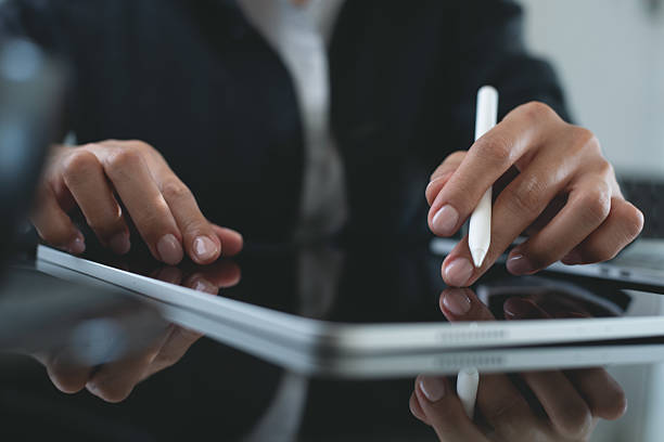 istock Businesswoman using digital tablet, reading e-document before signing via mobile app, proofing digital document. Business woman, project manager planning new project on tablet pc on office table, close up 2224046194
