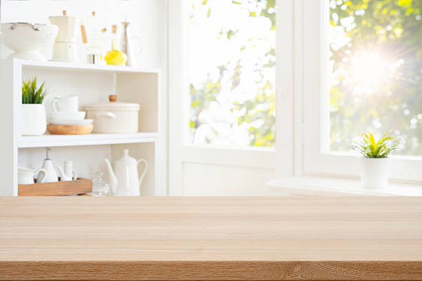 istock Empty wood table top on blurred window sill and shelf with kitchen ware background 2224048932