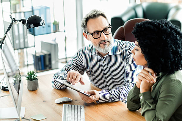 istock Professional colleagues discussing business strategies in a modern office setting with technology and a teamwork approach 2224049607