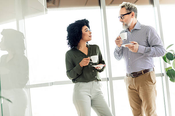 istock Professional colleagues conversing during a coffee break in a modern office environment emphasizing collaboration and teamwork. 2224049642