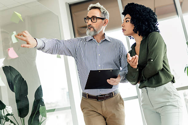 istock Professional colleagues collaborating in a bright modern office environment, brainstorming ideas on strategy and projects 2224049674