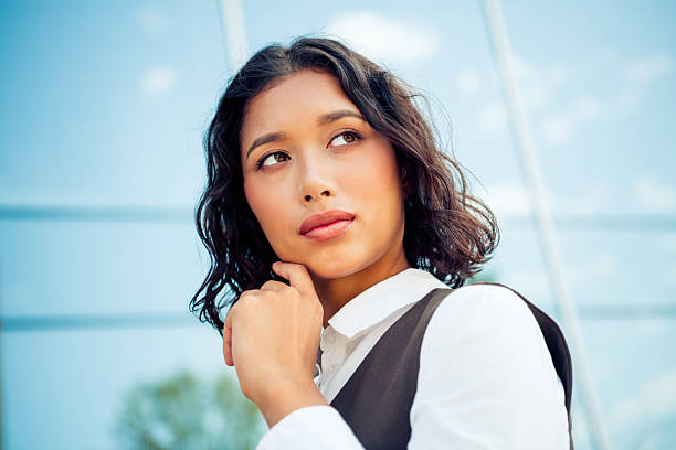 istock Professional woman outdoors in a modern urban setting with a confident expression, wearing stylish formal wear 2224051137