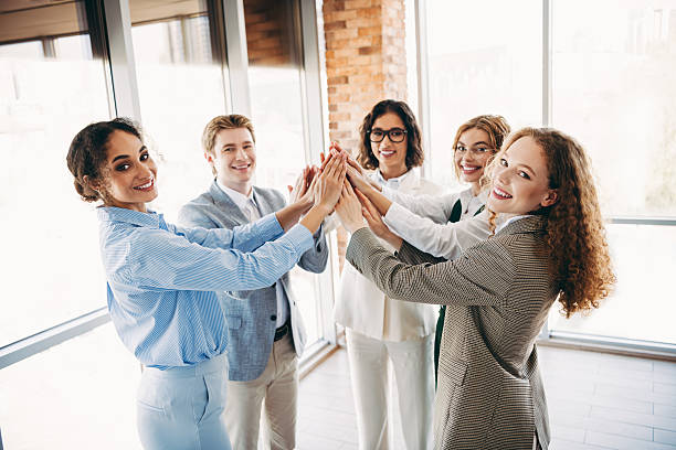 istock Diverse colleagues share a motivating moment in a contemporary office environment 2224053484