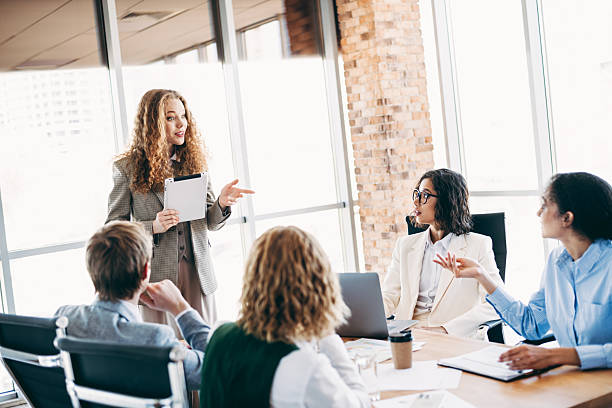istock Team members discussing project goals and collaboration strategies in a modern office setting during a business meeting 2224053518