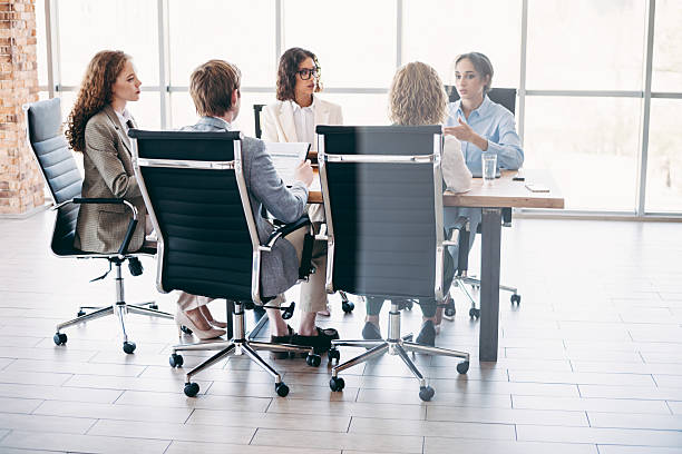istock Office team collaborating during a professional meeting in a modern workspace with a team of executives engaged in discussion 2224053541