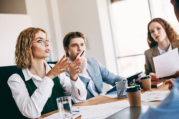 istock Professional colleagues engaging in a collaborative business meeting discussion at modern office workspace with teamwork focus 2224053556