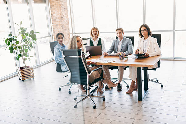 istock Group of Professionals Collaborating in Modern Workspace During Business Conference or Meeting 2224053787