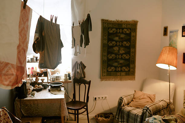 istock Empty Poor Room Featuring Laundry Drying Indoors in Warm Ambient Lighting 2224053968