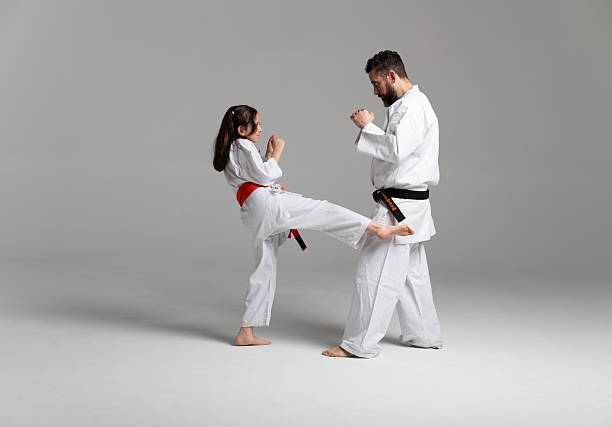 istock Girl kicking during kyokushinkai karate training with her coach 2224054135
