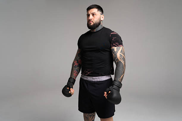 istock Mma fighter wearing gloves and looking away from camera 2224054142