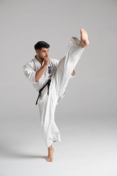 istock Kyokushinkai karate fighter kicking high with white uniform 2224054152