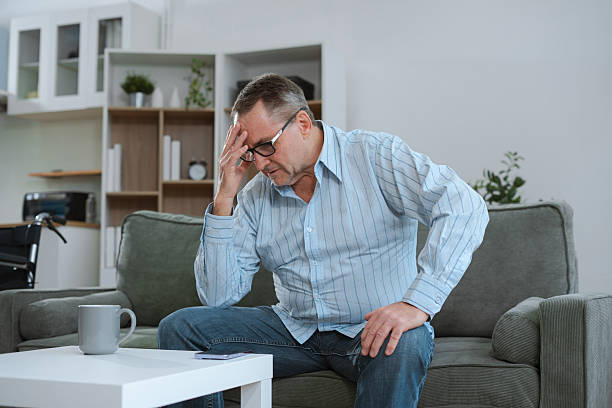 istock Senior man sitting in sofa, having depression, stress, irritability, and life problems. 2224055205