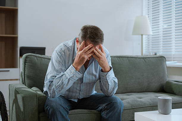 istock Senior man sitting in sofa, having depression, stress, irritability, and life problems. 2224055217