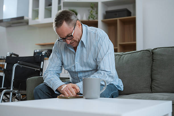 istock Senior man sitting in sofa, having depression, stress, irritability, and life problems. 2224055231