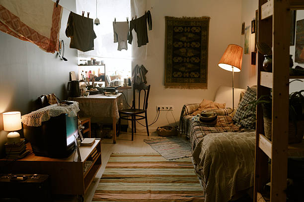 istock Poor Living Room Interior Featuring Laundry Drying and Warm Ambient Lighting 2224055594