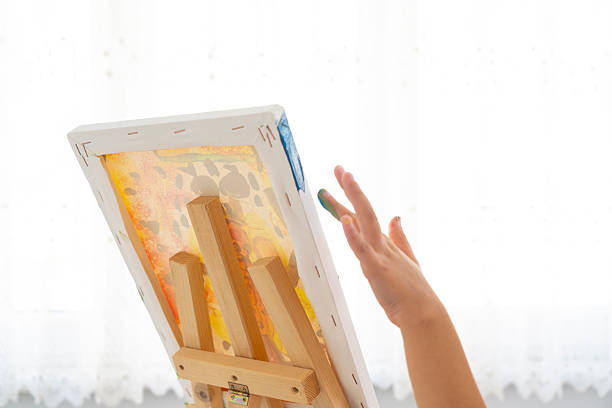 Young artist paints on canvas