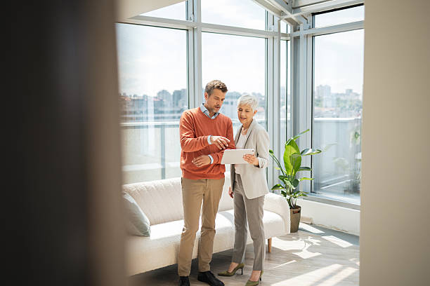 istock Two professionals collaborating in a bright modern office with tablet discussion 2224056641