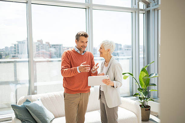 istock Senior business professionals discussing technology while referencing tablet in modern office space 2224056647