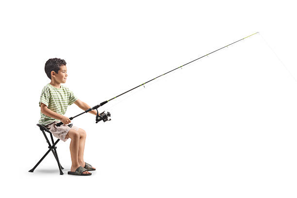 Beautiful woman in a beautiful summer dress, fishing on the lake, on a summer evening.