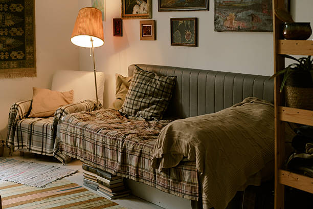istock Cozy Living Room Interior Featuring Sofa and Armchair with Warm Lighting 2224057940