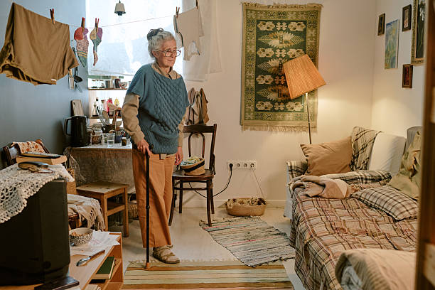 Senior Caucasian Woman Standing with Cane in Modest Home Interior Setting