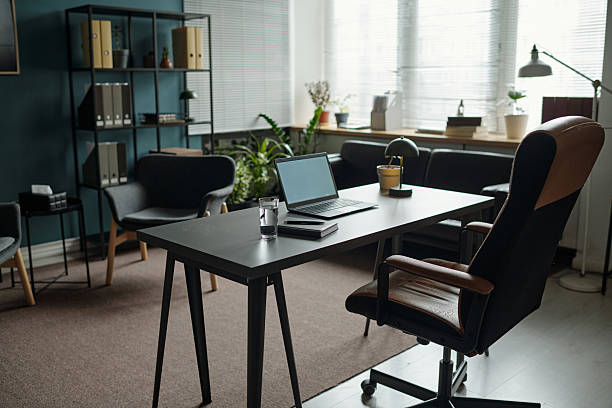 istock Empty Therapist Office Featuring Desk and Laptop Awaiting Counseling Session 2224059887
