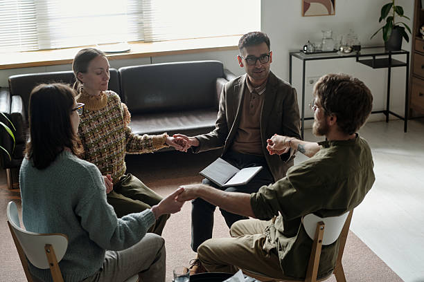 istock Multiethnic Young Adults Participating in Group Therapy Session Holding Hands 2224061875