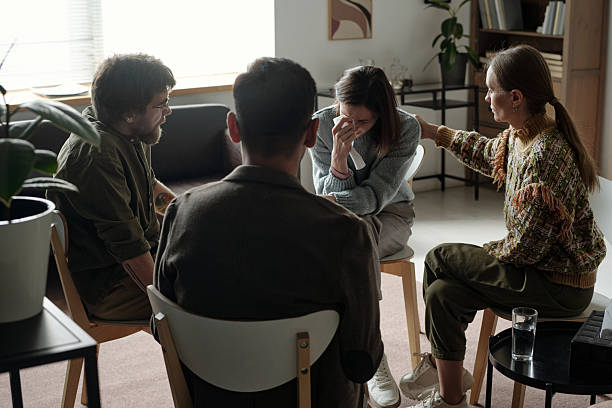 istock Young Woman Receiving Support during Group Therapy Session Indoors 2224062797