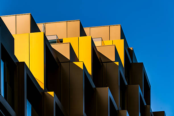 istock Zigzagging yellow balconies with bold sunlight and deep shadows against a vivid blue sky 2224063934