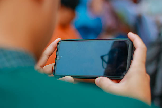 istock seen from behind people playing on the phone 2224065074