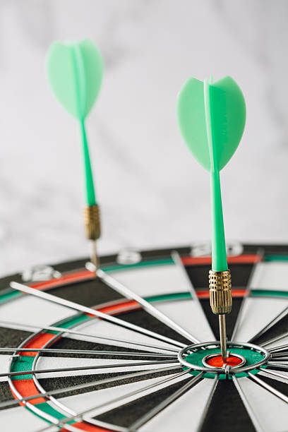 istock Green Dart Arrows in Bullseye on Classic Dartboard Array 2224065659