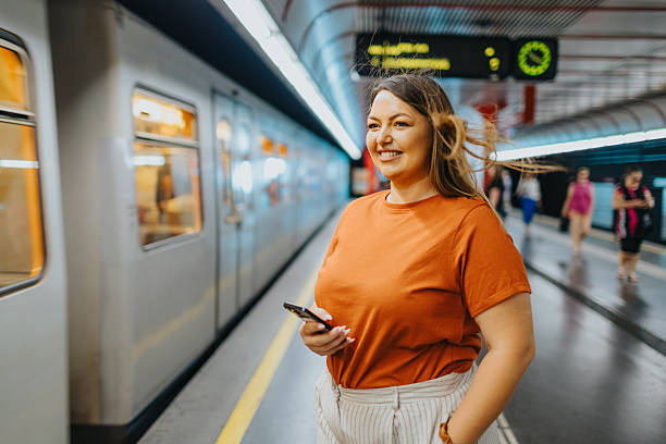 istock Smiling woman waiting for the train 2224066148