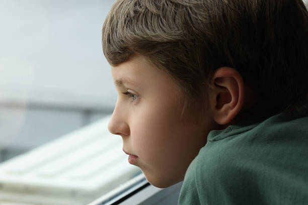 istock Autism concept. Lonely little boy near window at home, space for text 2224066176