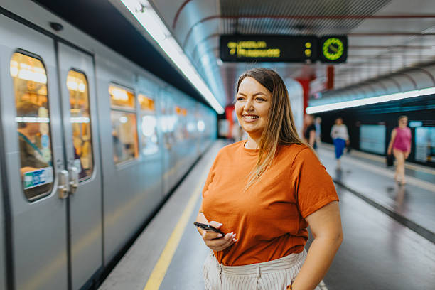 istock Smiling woman waiting for the train 2224066703