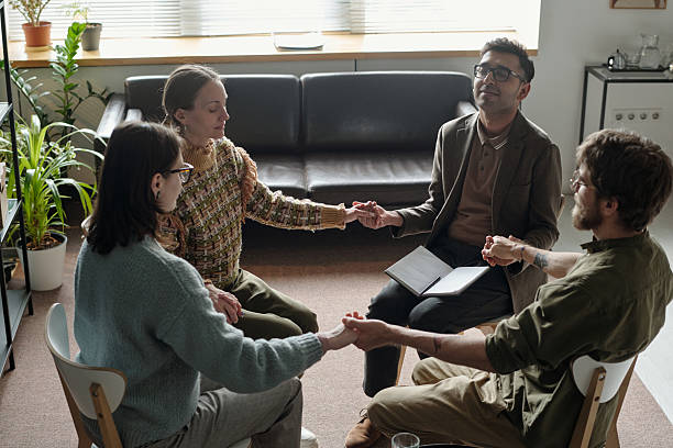 istock Diverse Young Adults Participating in Group Therapy Session Holding Hands 2224066878