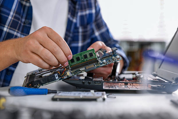 istock Man installing motherboard into laptop at white table, closeup 2224067041