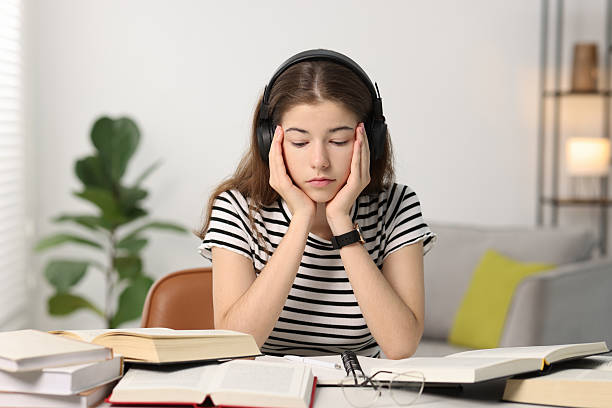 istock Preparing for exam. Tired student sleeping at table indoors 2224067212